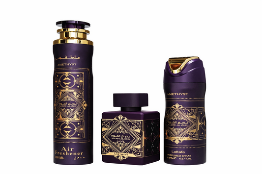 Lattafa Bade’e Al Oud Gift Set shown with Eau de Parfum bottle, deodorant spray and air freshener in premium purple‑and‑gold on a pure white background.