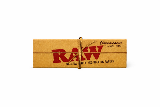 RAW Connoisseur 1¼ Size rolling papers with tips single pack shown in natural‑brown branded packaging on a pure white background.