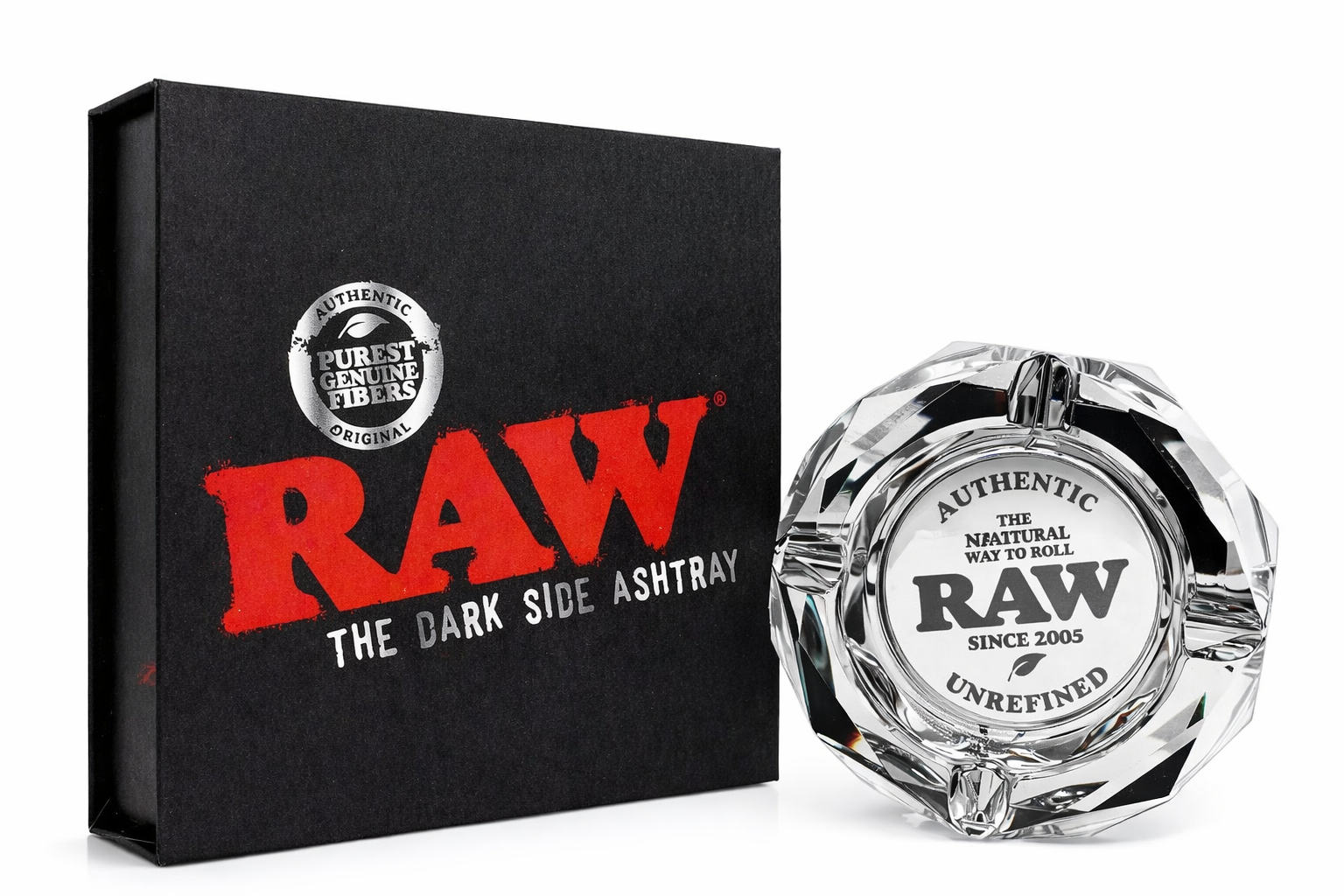 RAW Limited Edition Glass Ashtray displayed beside its black box packaging on a pure white background, featuring “RAW The Dark Side Ashtray” branding and engraved authentic RAW logo details.
