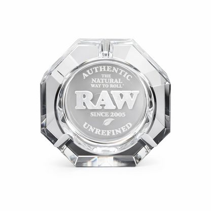 Clear glass ashtray with 'RAW' branding on a white background